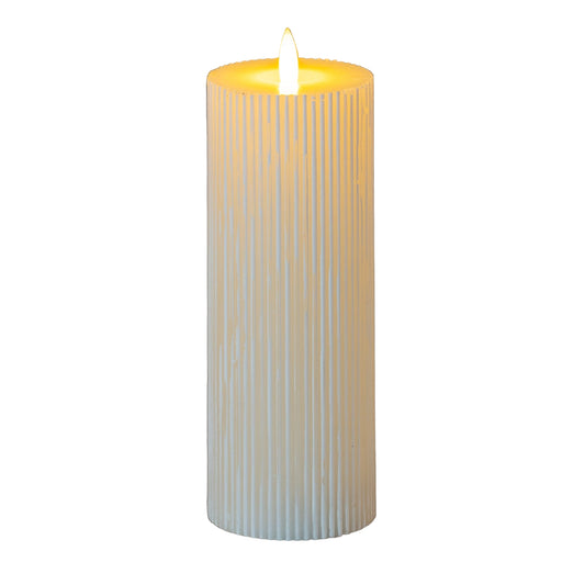 Cylindrical candle with a ribbed texture and lit flame on a gray background