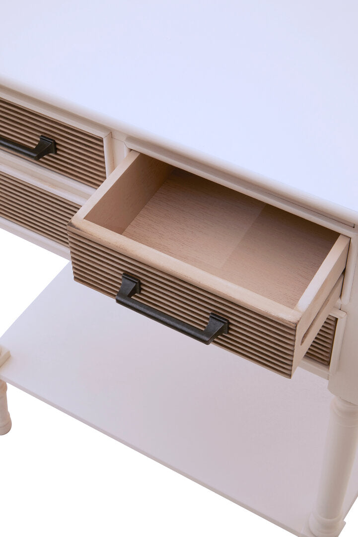 Close-up of a white desk with an open drawer, showing wooden interior and metal handle.