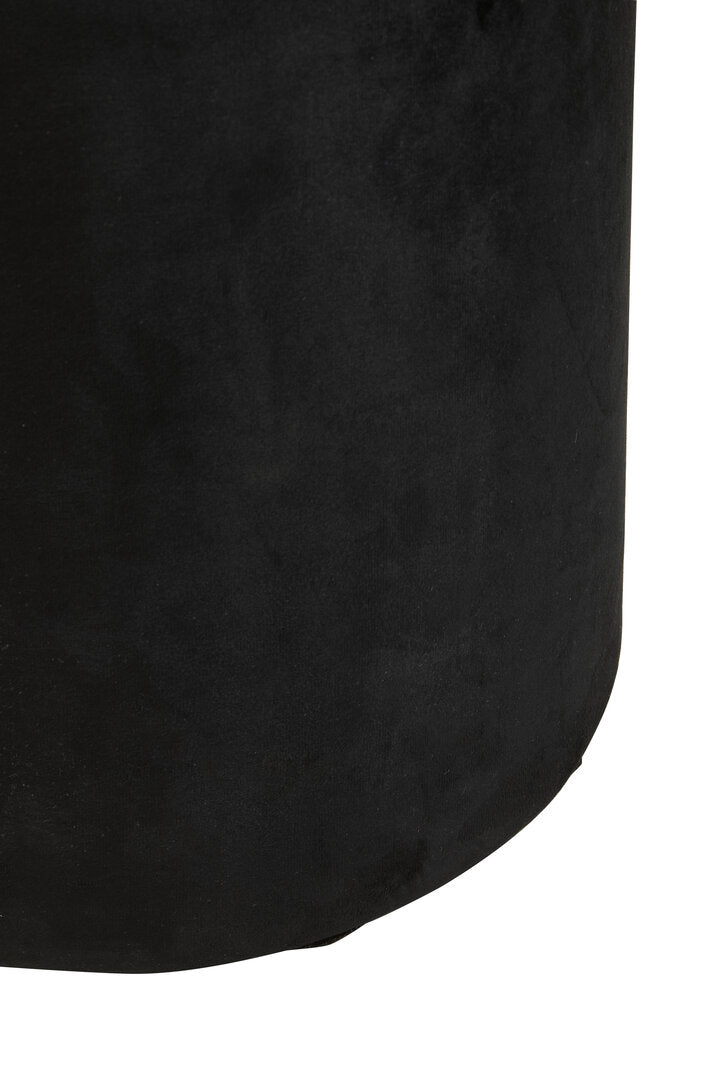Close-up of a black textured cylindrical object on a white background