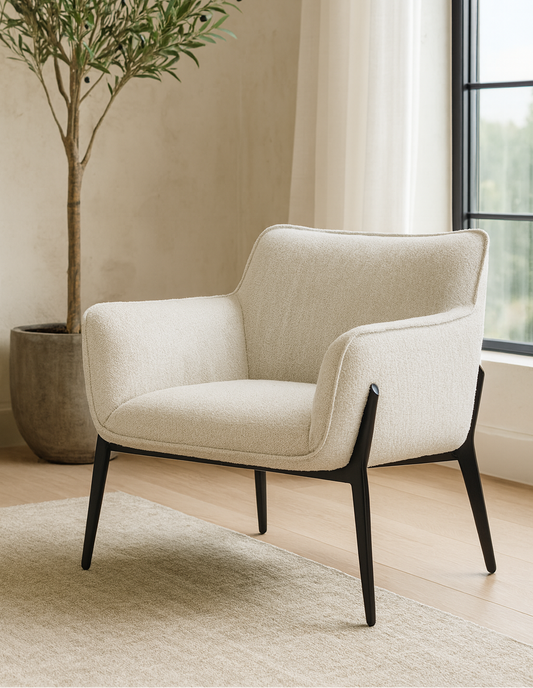 Beige armchair in a room with a plant and window