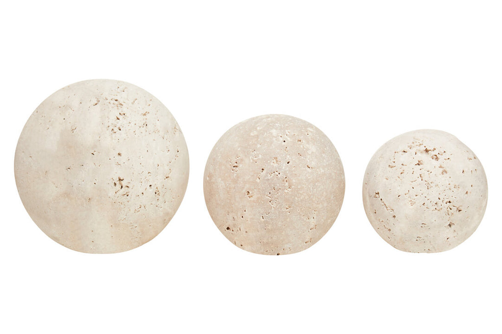 Three beige bath bombs on a white background