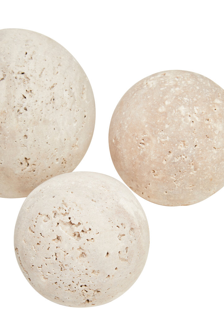 Three beige bath bombs on a white background