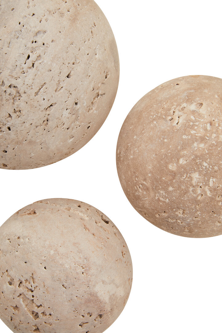 Three beige stone balls on a white background
