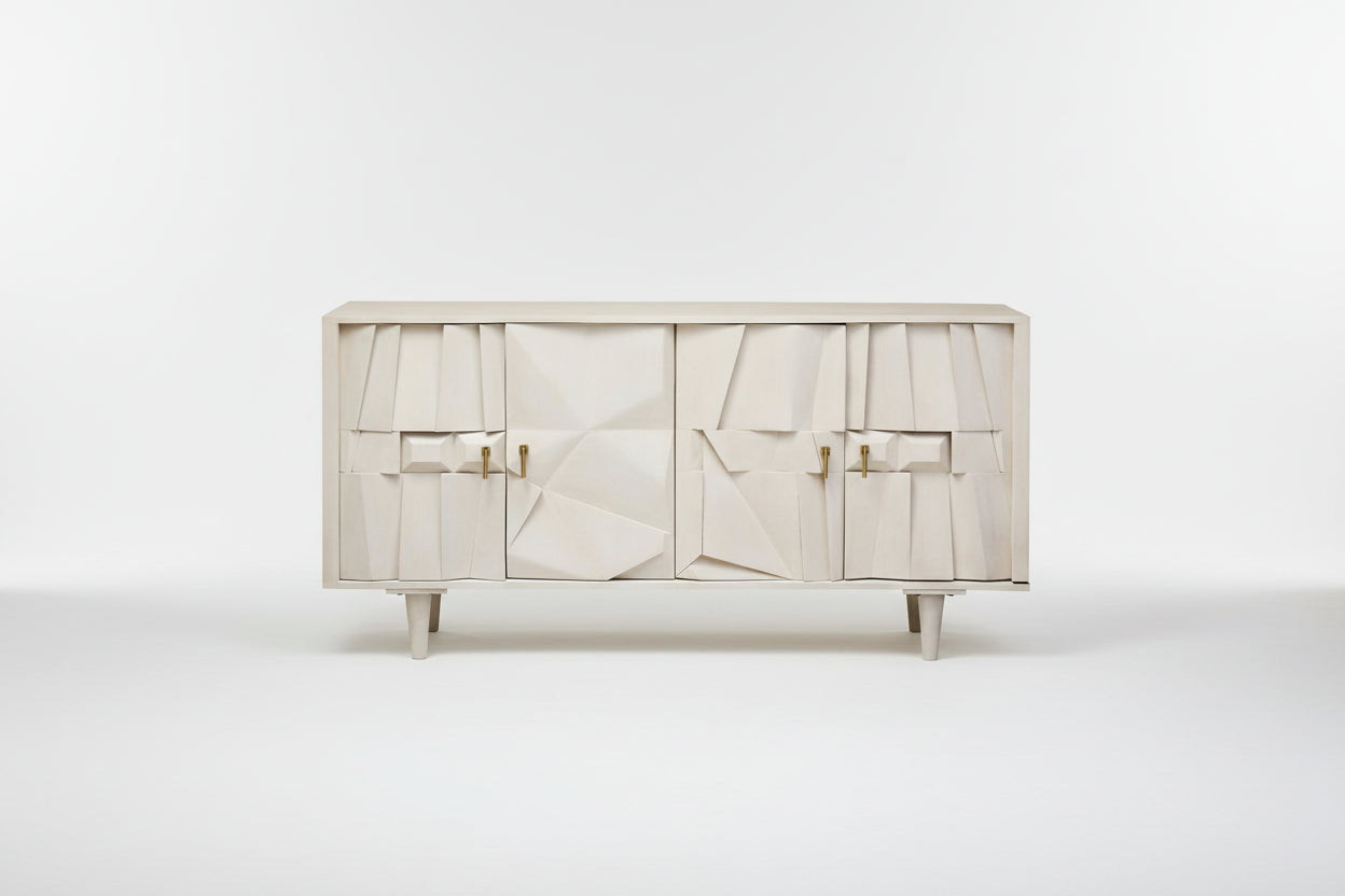 White cabinet with abstract design and gold handles on a white background