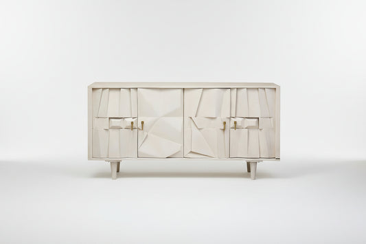 White cabinet with abstract design and gold handles on a white background
