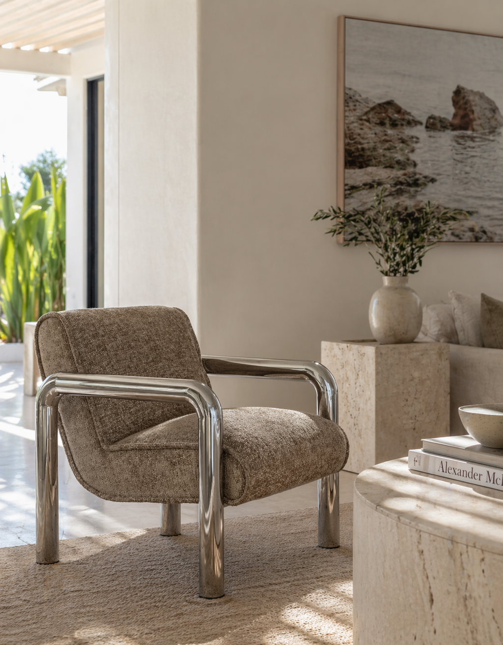 Modern armchair with chrome frame in a stylish living room setting.