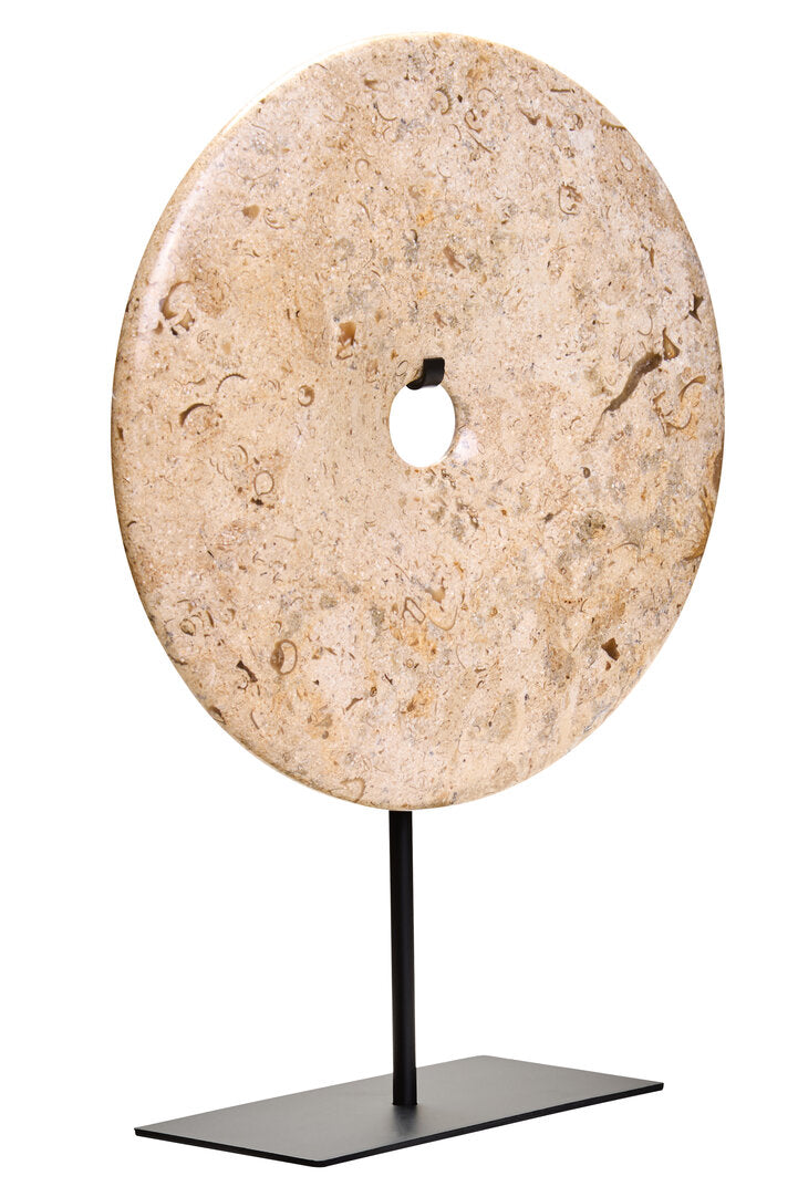 Round stone disc on a black stand against a white background