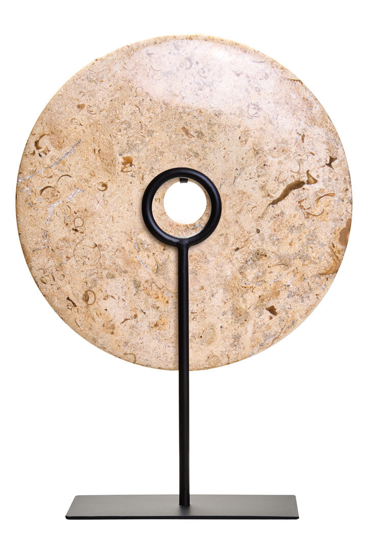 Decorative stone disc on a black stand against a white background