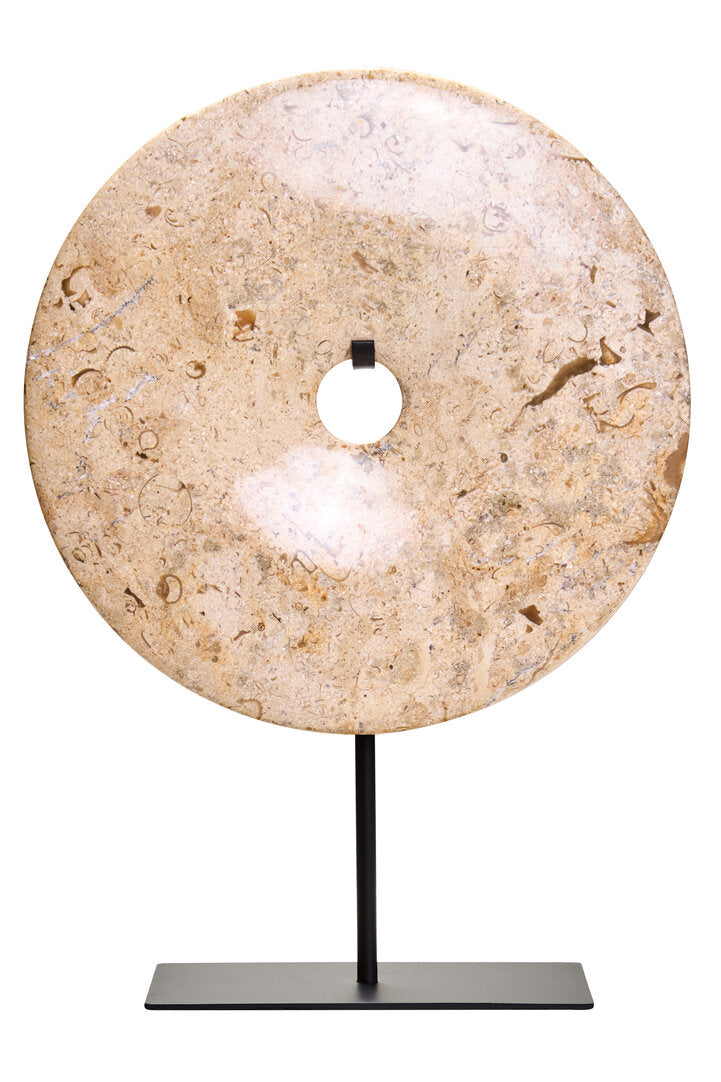 Stone disc on a stand against a white background