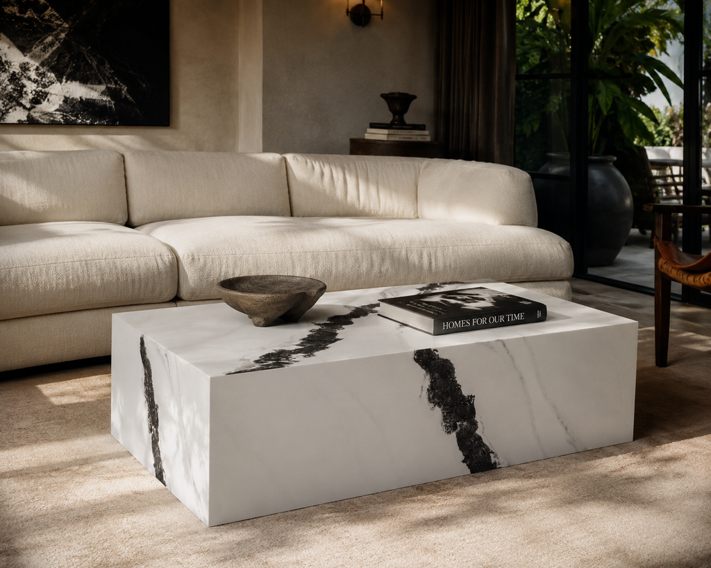 Modern living room with a beige sectional sofa and a marble coffee table.