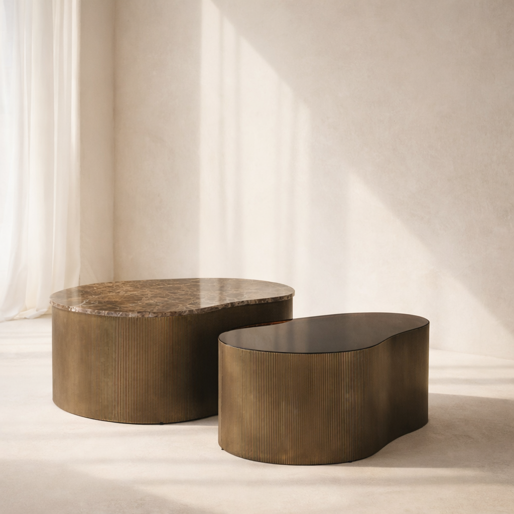 Two bronze coffee tables with a textured surface on a neutral background