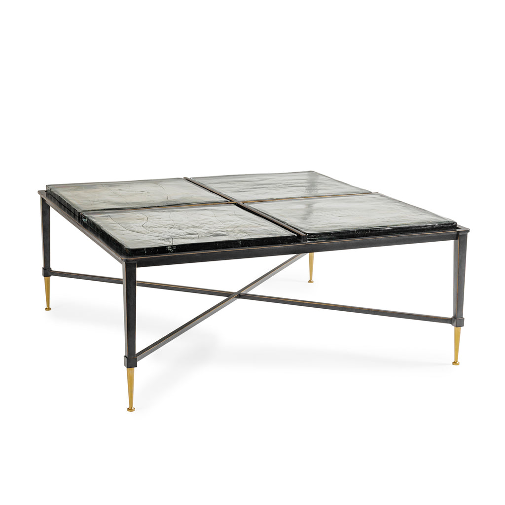 Square glass table with black metal frame on a white background