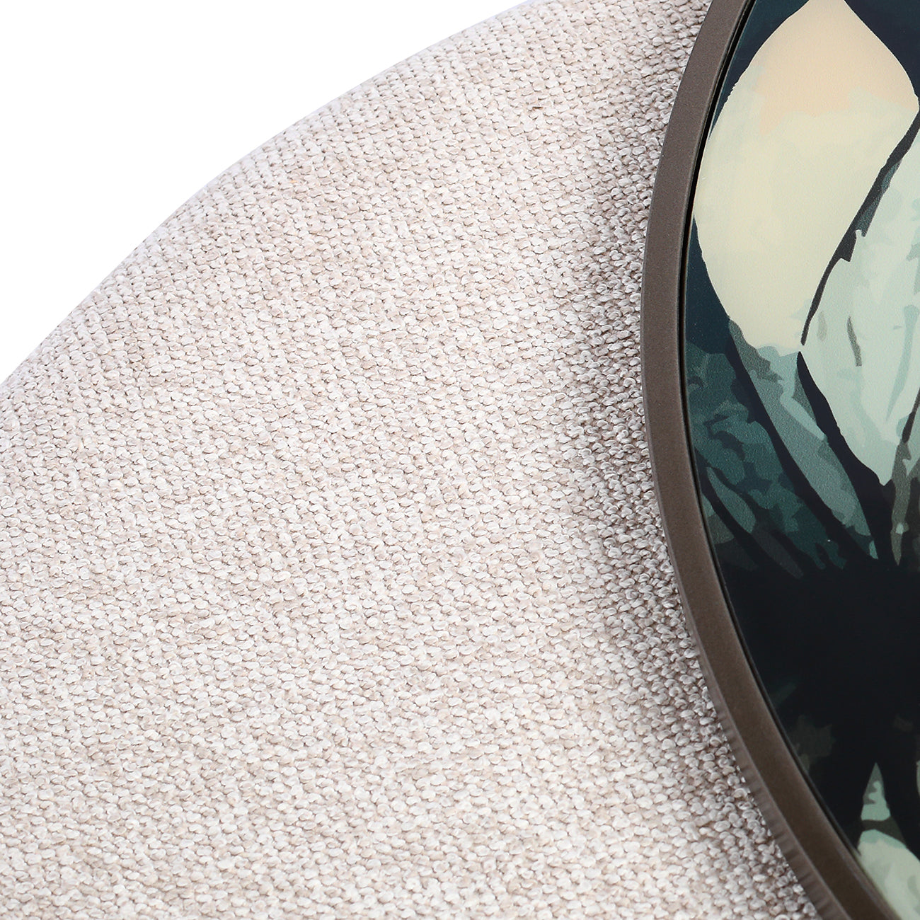 Close-up of a textured surface with a circular object featuring a nature-themed design.