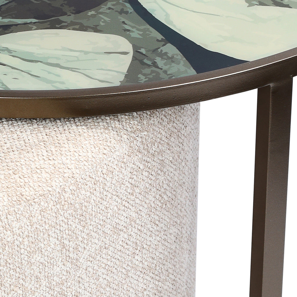 Close-up of a round glass table with a textured surface and metal frame.