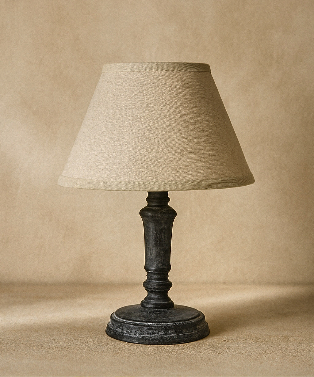 Table lamp with beige shade on a beige background