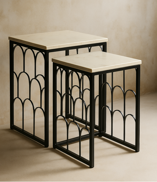 Set of two nesting tables with marble tops and black metal frames on a beige background