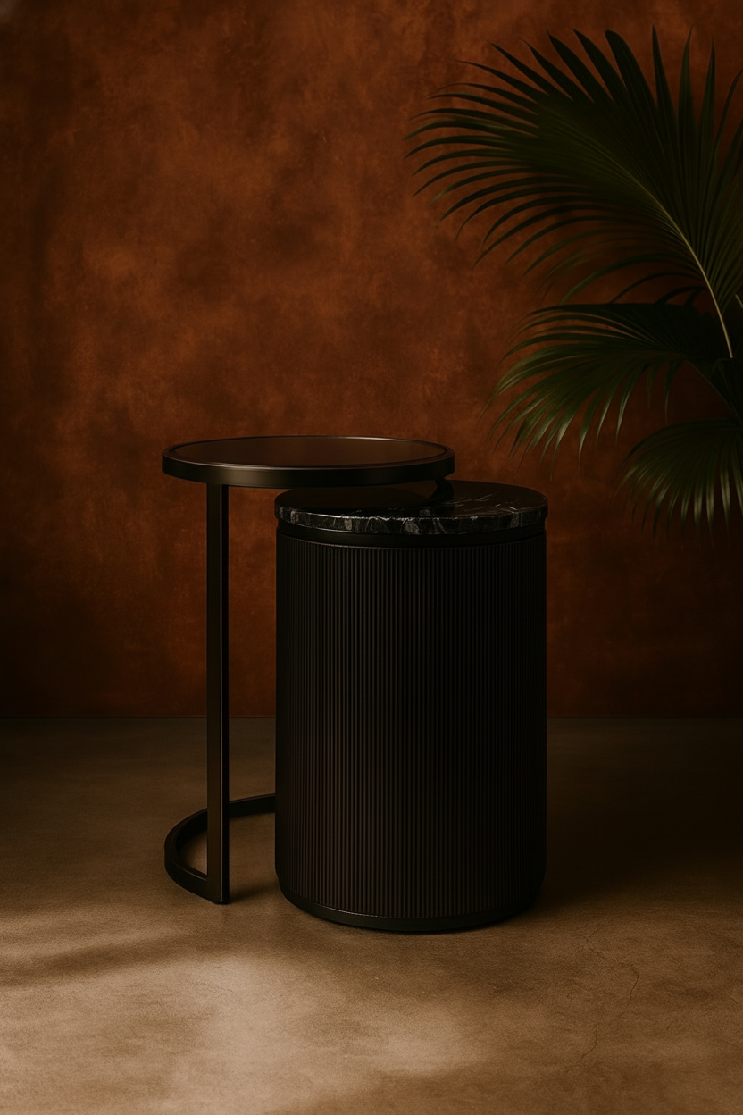 Black cylindrical stool against a brown textured wall with a plant.