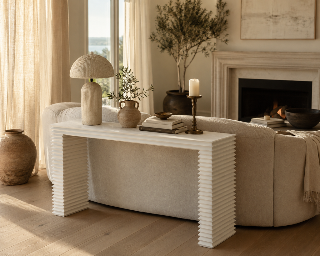 Living room with a white console table, beige sofa, and decorative items.