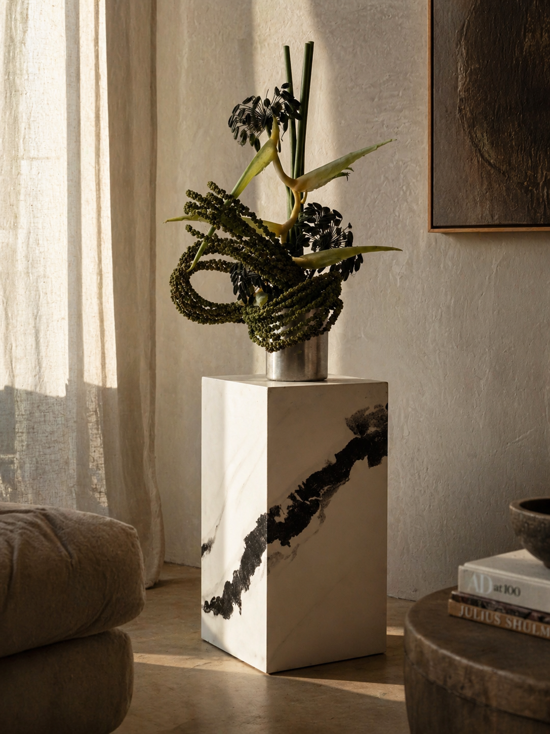 Decorative plant on a white marble pedestal in a living room setting